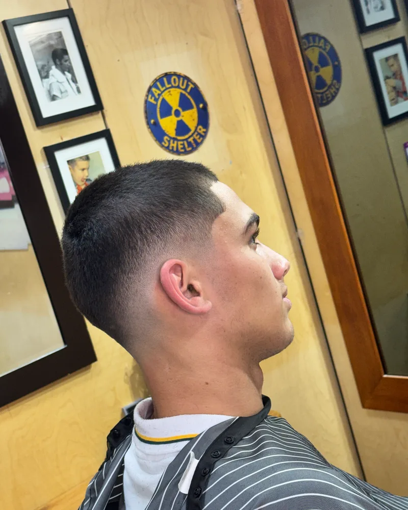 Side profile of a buzz cut with a mid skin fade and a straight line-up