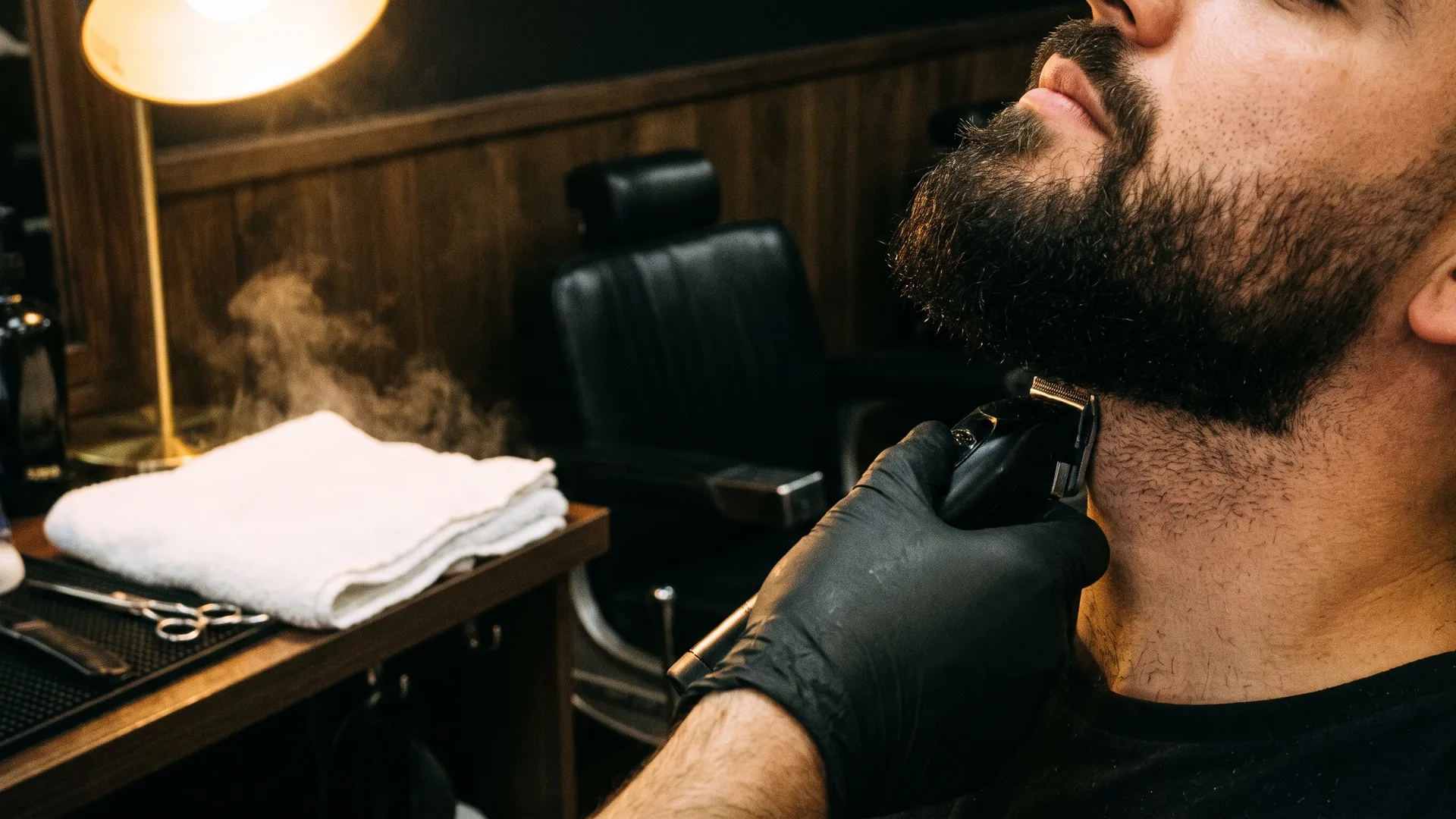 A barber lining up a full beard with a cordless trimmer